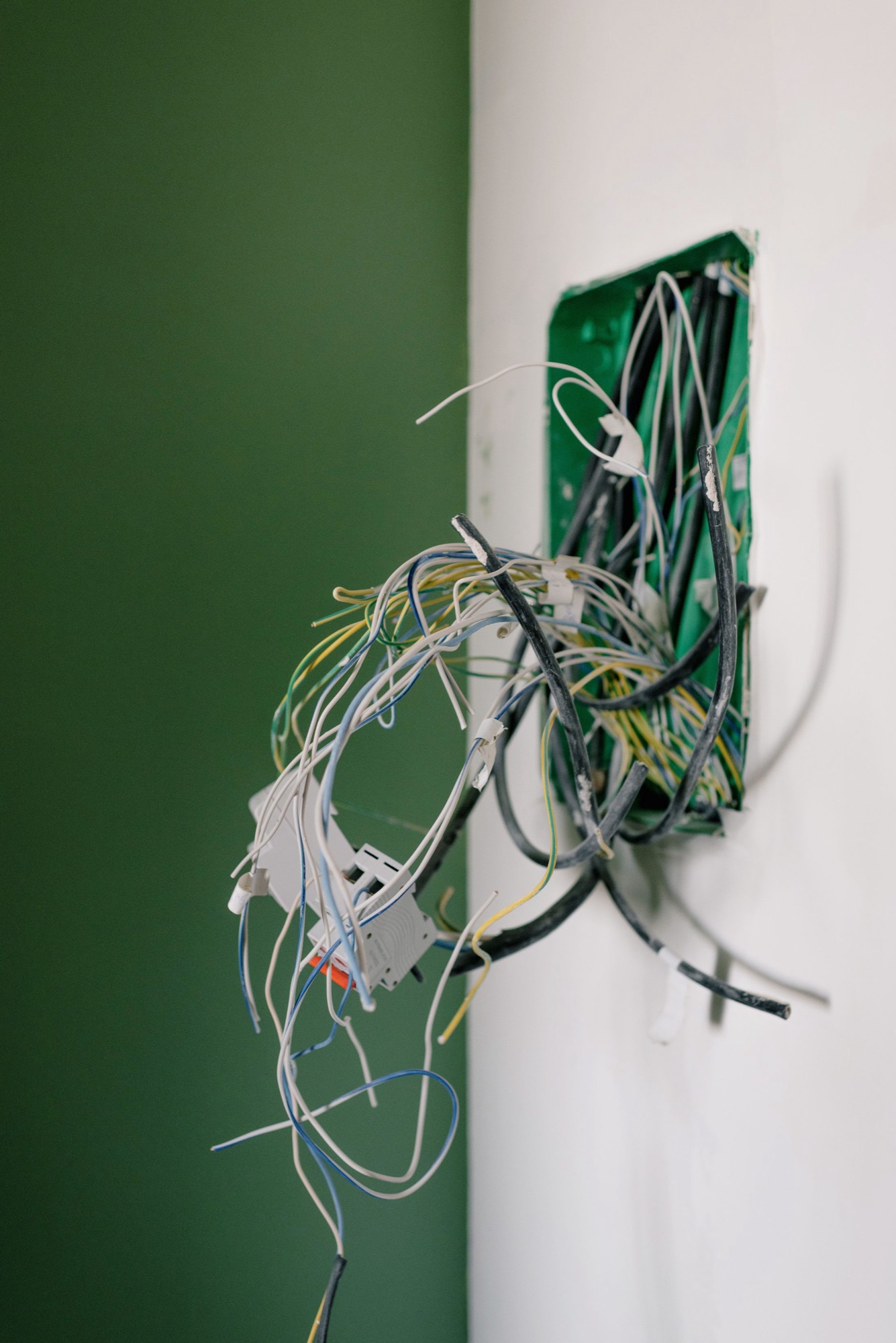 New cabling pulled out of a wall box part-way through a first fix